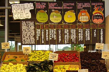 English: A display of hot peppers and a board ...